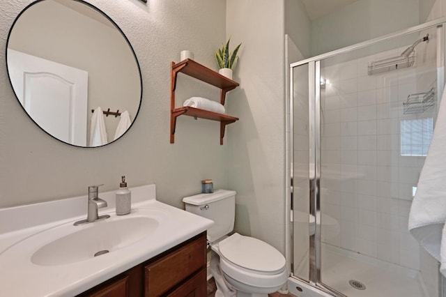 full bath featuring vanity, toilet, and a stall shower