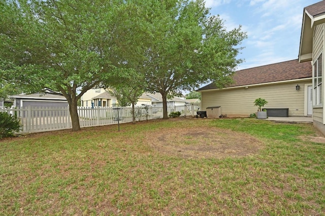 view of yard with fence and a garage