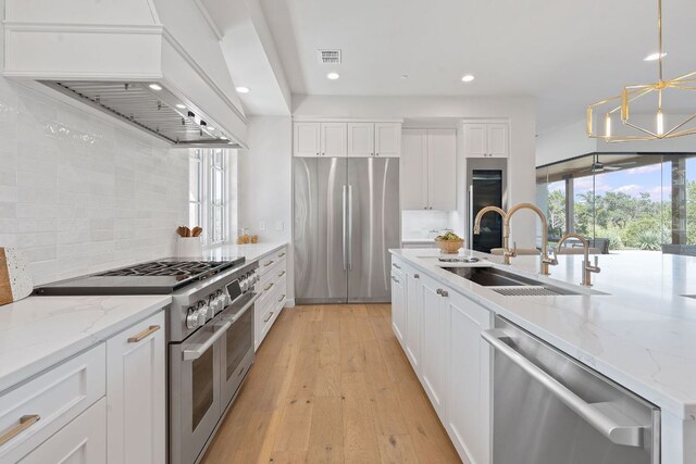 6013 Silver Luna Way, Austin, TX 78738 - kitchen with a sink, recessed lighting, custom range hood, tasteful backsplash, and premium appliances