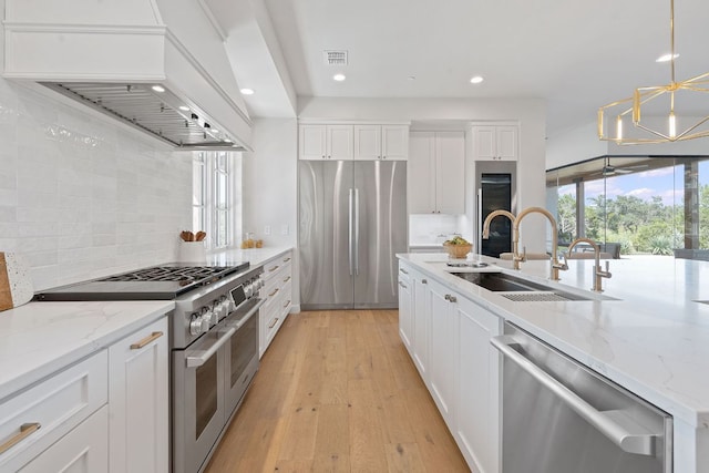 6013 Silver Luna Way, Austin, TX 78738 - kitchen featuring stainless steel appliances, custom range hood, recessed lighting, tasteful backsplash, and white cabinetry