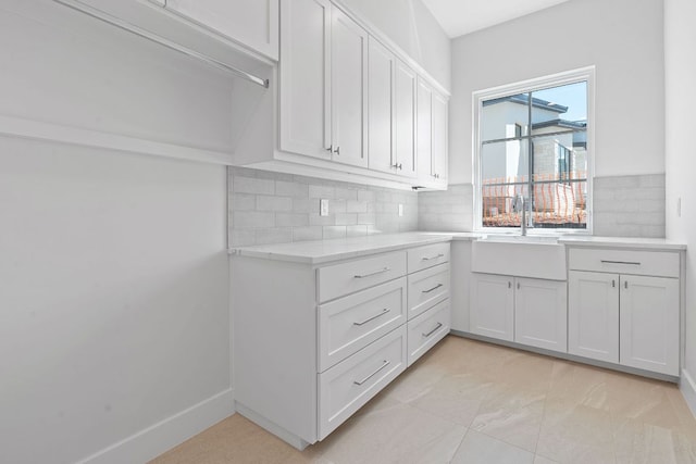 6013 Silver Luna Way, Austin, TX 78738 - kitchen featuring tasteful backsplash, white cabinetry, and light stone counters