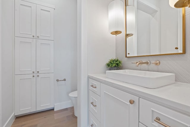 6013 Silver Luna Way, Austin, TX 78738 - bathroom with toilet, baseboards, wood finished floors, and vanity