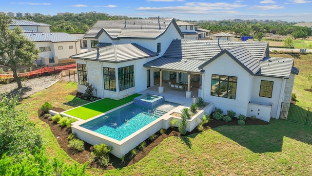 6013 Silver Luna Way, Austin, TX 78738 - back of house with a patio, a fenced backyard, stucco siding, a standing seam roof, and a yard