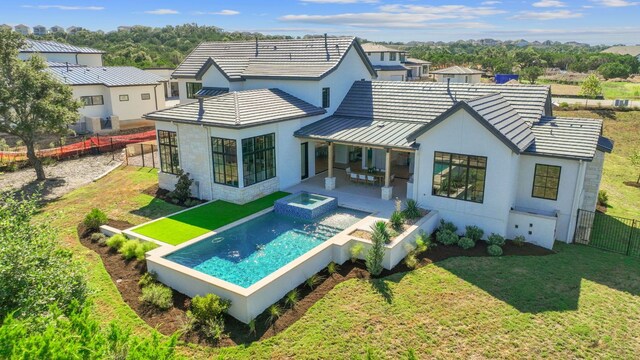 6013 Silver Luna Way, Austin, TX 78738 - rear view of house with a fenced backyard, a standing seam roof, a patio, and stucco siding