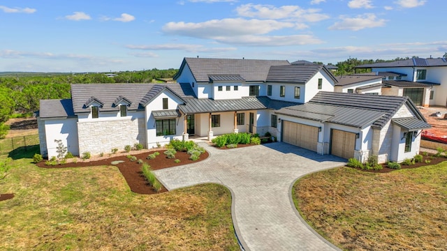 6013 Silver Luna Way, Austin, TX 78738 - modern inspired farmhouse featuring a garage, a front lawn, covered porch, a standing seam roof, and driveway