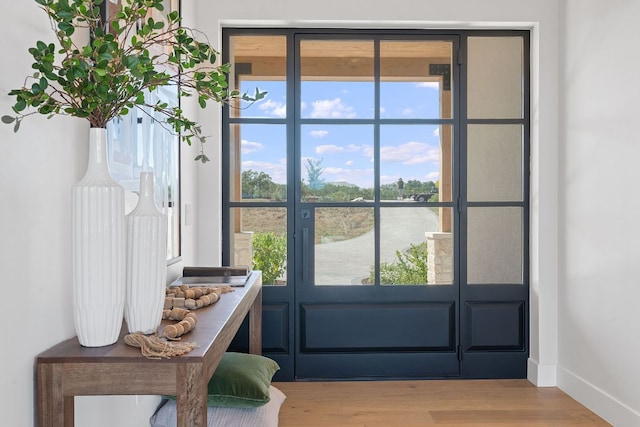 6013 Silver Luna Way, Austin, TX 78738 - doorway to outside featuring baseboards and wood finished floors