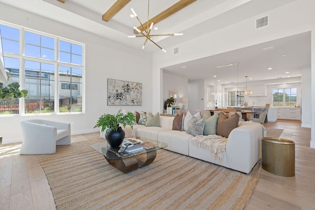 6013 Silver Luna Way, Austin, TX 78738 - living area featuring visible vents, recessed lighting, light wood finished floors, and a notable chandelier