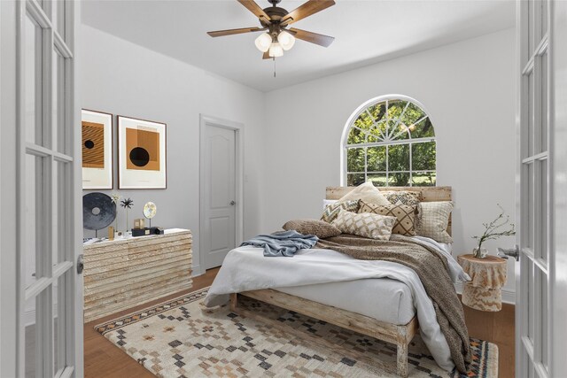 bedroom with ceiling fan and wood finished floors