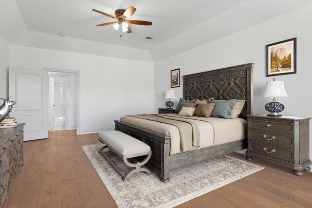 bedroom with ceiling fan, light wood-style flooring, and visible vents