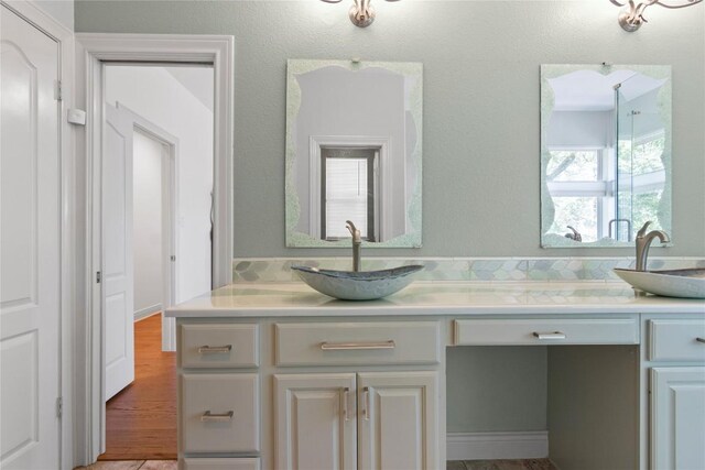 bathroom with double vanity and a sink