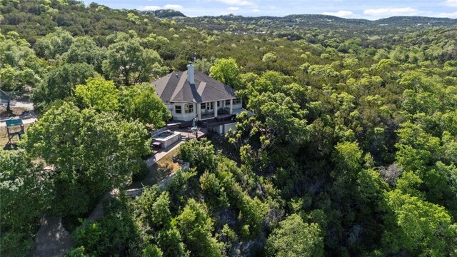 drone / aerial view with a wooded view