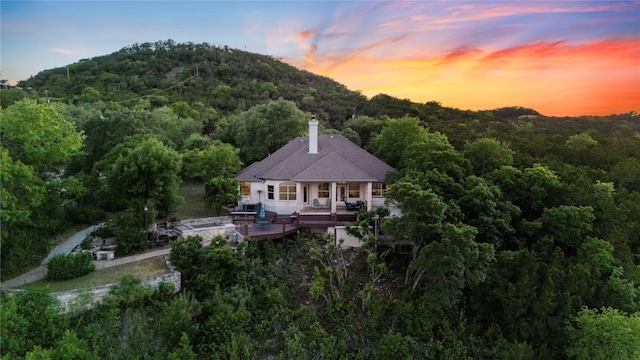 birds eye view of property featuring a view of trees