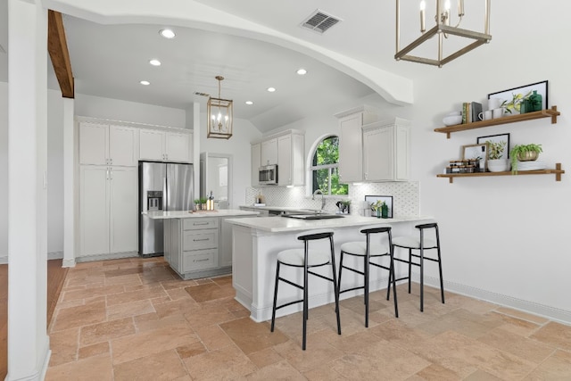 kitchen featuring visible vents, decorative backsplash, an inviting chandelier, recessed lighting, and appliances with stainless steel finishes