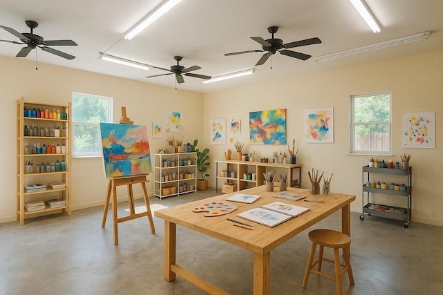rec room with baseboards and ceiling fan