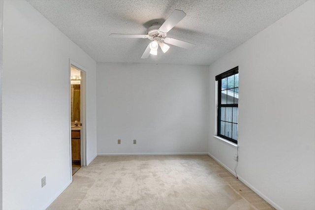 8518 Fathom Cir Unit 107, Austin, TX 78750 - unfurnished room featuring a textured ceiling, light carpet, ceiling fan, and baseboards