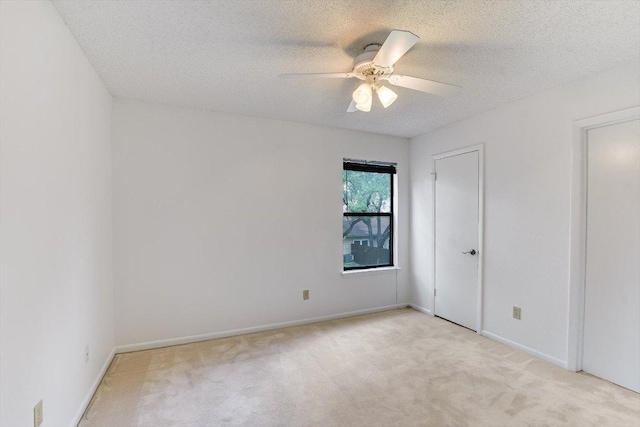 8518 Fathom Cir Unit 107, Austin, TX 78750 - unfurnished bedroom featuring light colored carpet, a textured ceiling, baseboards, and ceiling fan