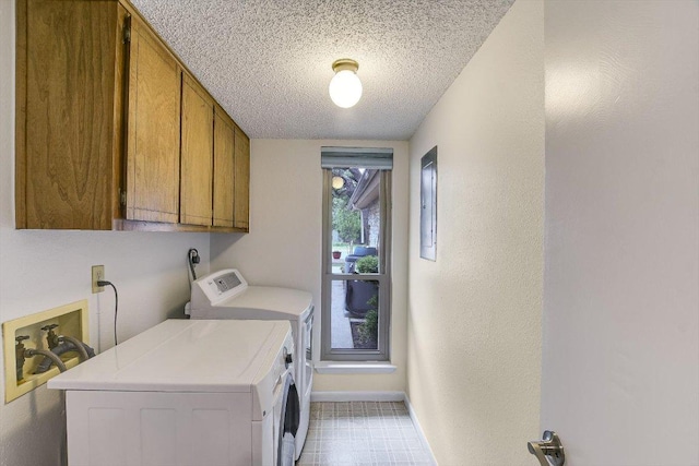 8518 Fathom Cir Unit 107, Austin, TX 78750 - laundry room featuring cabinet space, washing machine and dryer, a textured ceiling, and electric panel