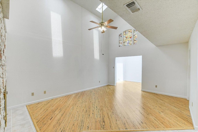 8518 Fathom Cir Unit 107, Austin, TX 78750 - unfurnished living room with a ceiling fan, light wood-style flooring, baseboards, and high vaulted ceiling