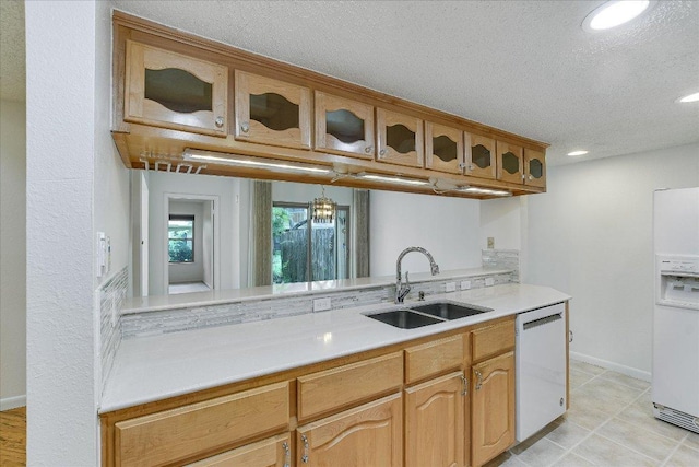 8518 Fathom Cir Unit 107, Austin, TX 78750 - kitchen featuring a sink, white appliances, light countertops, glass insert cabinets, and recessed lighting