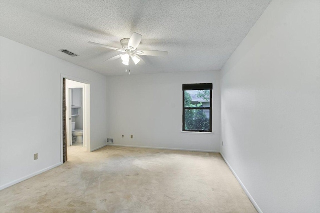 8518 Fathom Cir Unit 107, Austin, TX 78750 - empty room with light carpet, ceiling fan, a textured ceiling, and baseboards