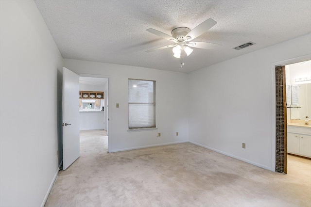8518 Fathom Cir Unit 107, Austin, TX 78750 - spare room featuring light carpet, ceiling fan, a textured ceiling, and baseboards