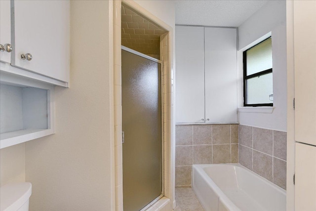 8518 Fathom Cir Unit 107, Austin, TX 78750 - bathroom with a garden tub, a shower stall, and toilet