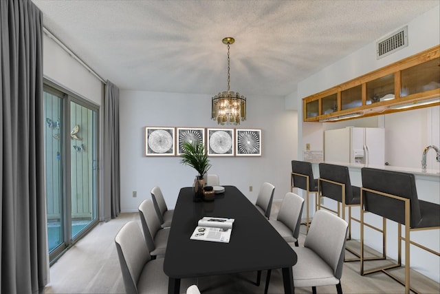 8518 Fathom Cir Unit 107, Austin, TX 78750 - dining space with a chandelier and a textured ceiling