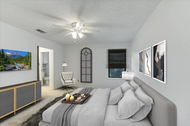 8518 Fathom Cir Unit 107, Austin, TX 78750 - carpeted bedroom featuring a textured ceiling, ceiling fan, and ensuite bath