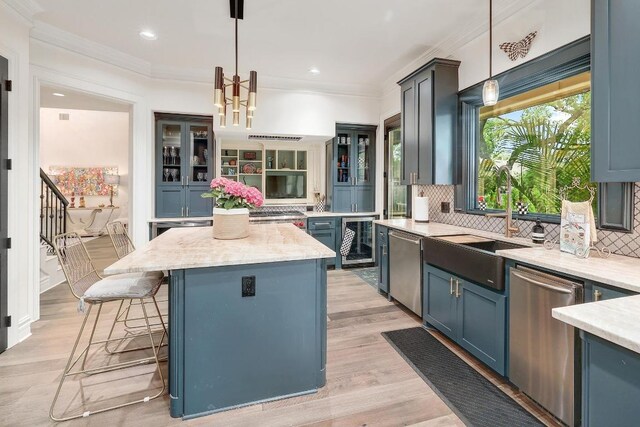 3705 Dogwood Creek Cv, Austin, TX 78746 - kitchen featuring stainless steel dishwasher, a kitchen island, glass insert cabinets, backsplash, and a kitchen breakfast bar
