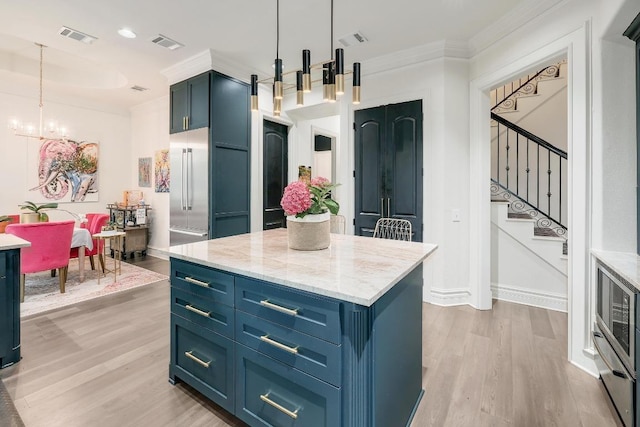 3705 Dogwood Creek Cv, Austin, TX 78746 - kitchen featuring blue cabinetry, visible vents, stainless steel built in fridge, and light wood-style floors