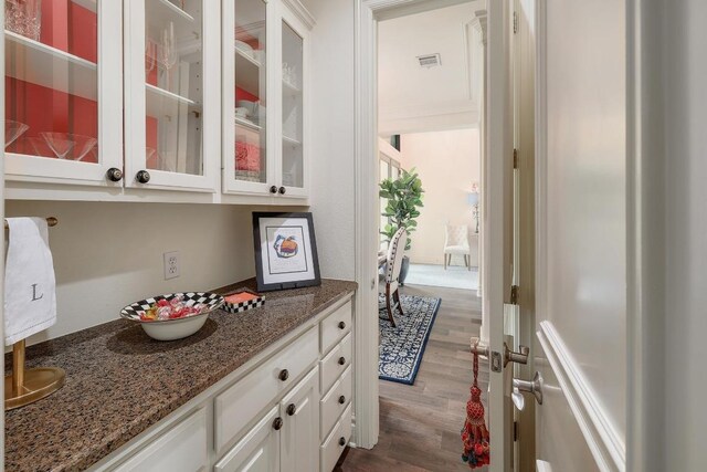 3705 Dogwood Creek Cv, Austin, TX 78746 - kitchen featuring white cabinets, dark wood finished floors, glass insert cabinets, and stone countertops