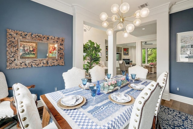 3705 Dogwood Creek Cv, Austin, TX 78746 - dining area featuring crown molding, a chandelier, baseboards, wood finished floors, and visible vents