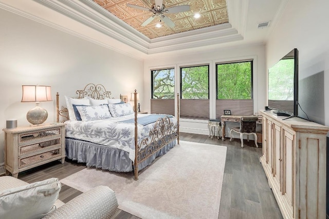 3705 Dogwood Creek Cv, Austin, TX 78746 - bedroom with ceiling fan, visible vents, dark wood finished floors, and a raised ceiling