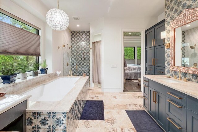 3705 Dogwood Creek Cv, Austin, TX 78746 - bathroom featuring a shower stall, vanity, a garden tub, connected bathroom, and recessed lighting