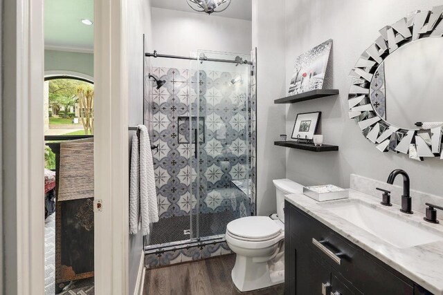 3705 Dogwood Creek Cv, Austin, TX 78746 - bathroom with vanity, a shower stall, wood finished floors, and crown molding