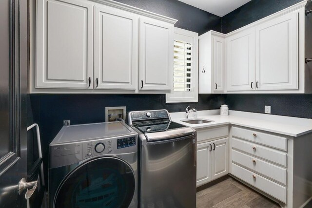 3705 Dogwood Creek Cv, Austin, TX 78746 - laundry area featuring cabinet space, independent washer and dryer, and wood finished floors