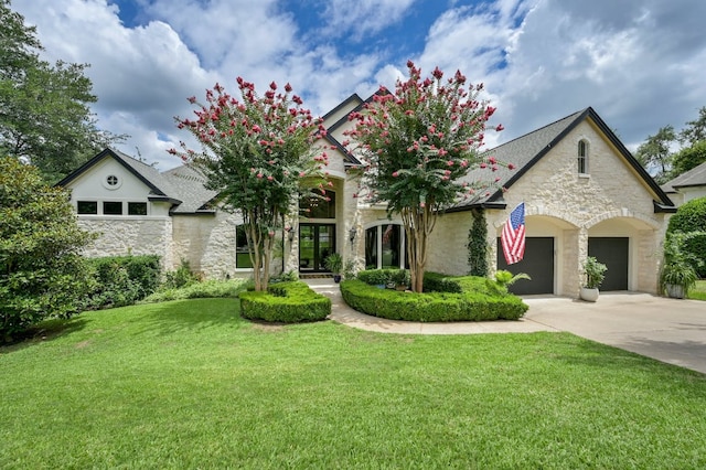3705 Dogwood Creek Cv, Austin, TX 78746 - view of front of house featuring an attached garage, a front yard, driveway, and stone siding