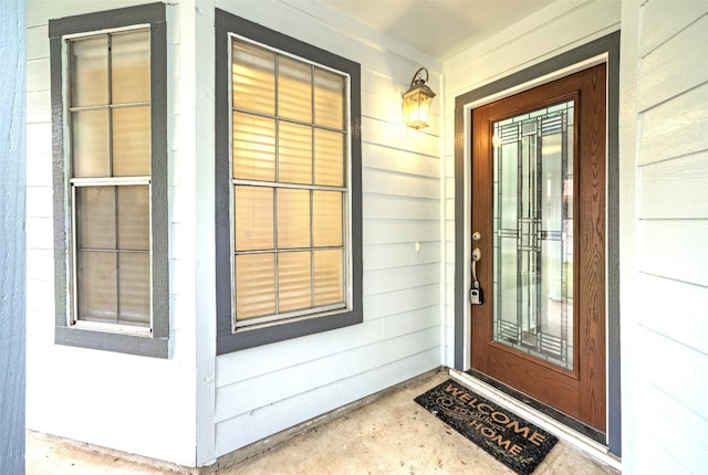 view of exterior entry featuring covered porch