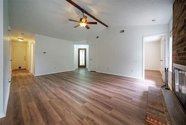 unfurnished living room featuring ceiling fan, wood finished floors, lofted ceiling, and a fireplace