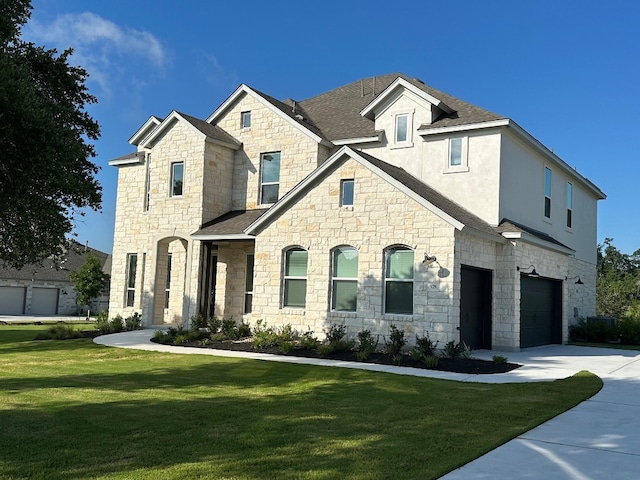 french provincial home with driveway, a front lawn, stone siding, and a garage