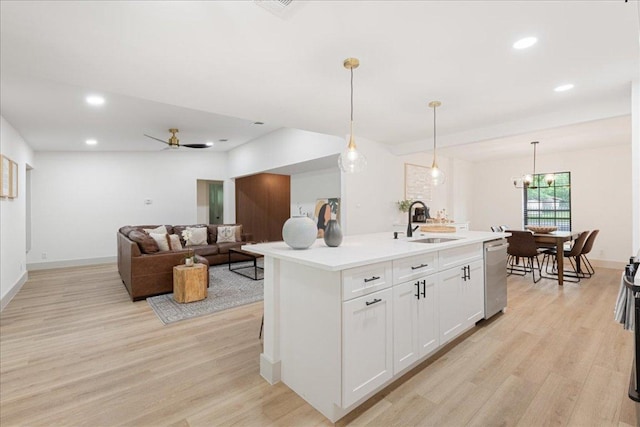 kitchen with light countertops, white cabinetry, a sink, light wood-style flooring, and dishwasher
