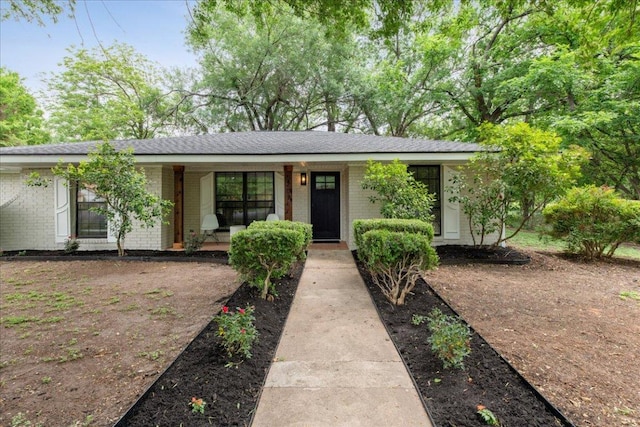view of front of property with brick siding and covered porch