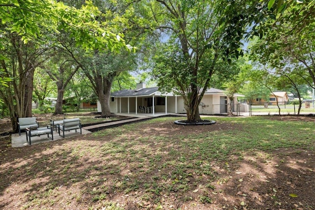 view of yard featuring a patio and fence