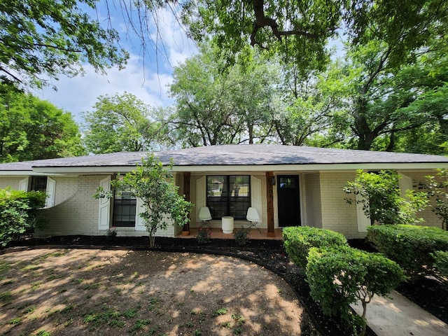 ranch-style house with brick siding and a porch