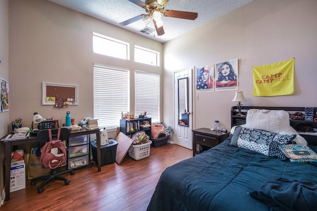2802 Nueces St Unit 312, Austin, TX 78705 - bedroom featuring wood finished floors, a textured ceiling, ceiling fan, and a towering ceiling