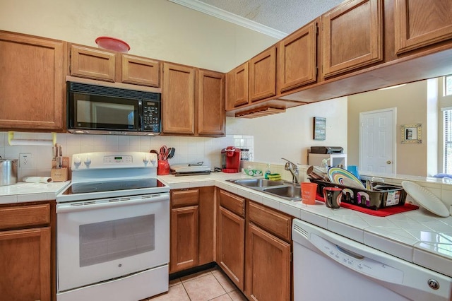kitchen featuring white appliances, crown molding, a sink, and tasteful backsplash