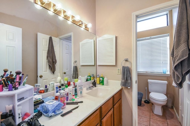 bathroom featuring vanity, tile patterned floors, and toilet