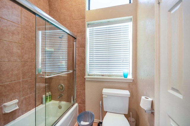 full bath featuring toilet and enclosed tub / shower combo