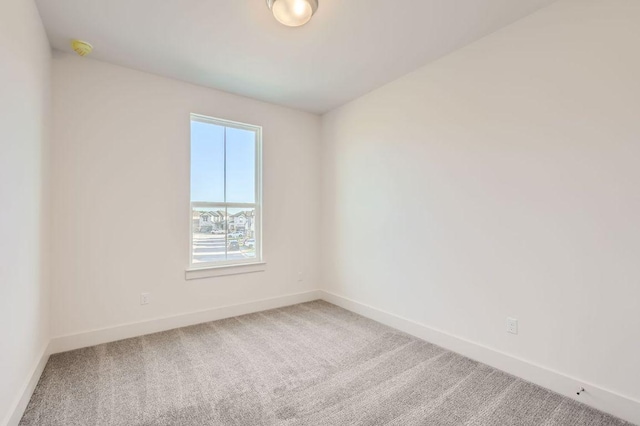 unfurnished room featuring baseboards and carpet flooring
