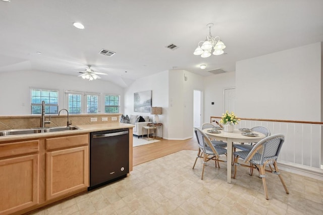 kitchen featuring visible vents, a sink, light floors, and black dishwasher